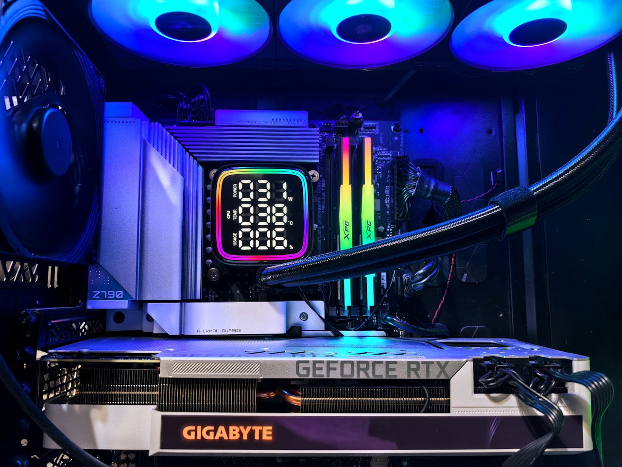 Vibrant RGB-lit gaming PC interior showcasing GeForce RTX and GIGABYTE components.