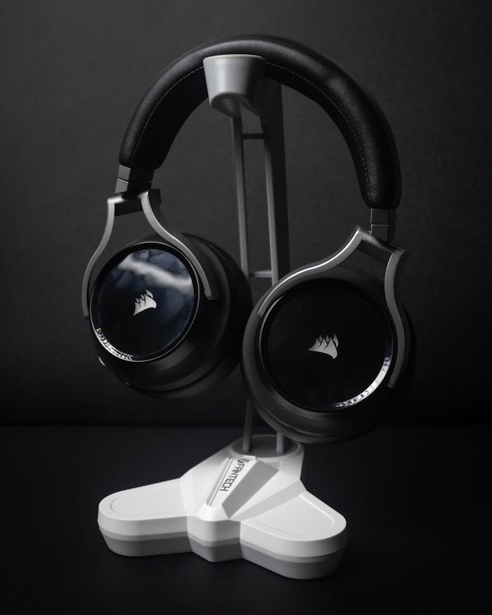 High-quality Corsair wireless headphones displayed on a modern stand.